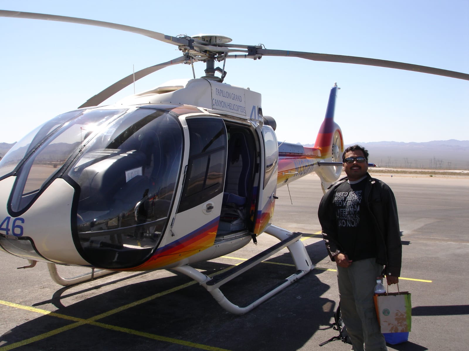 KP standing by a helicopter on a runway